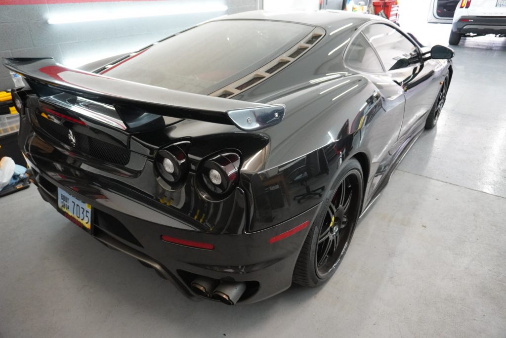 Black Ferrari 430 after paint protection film, rear view