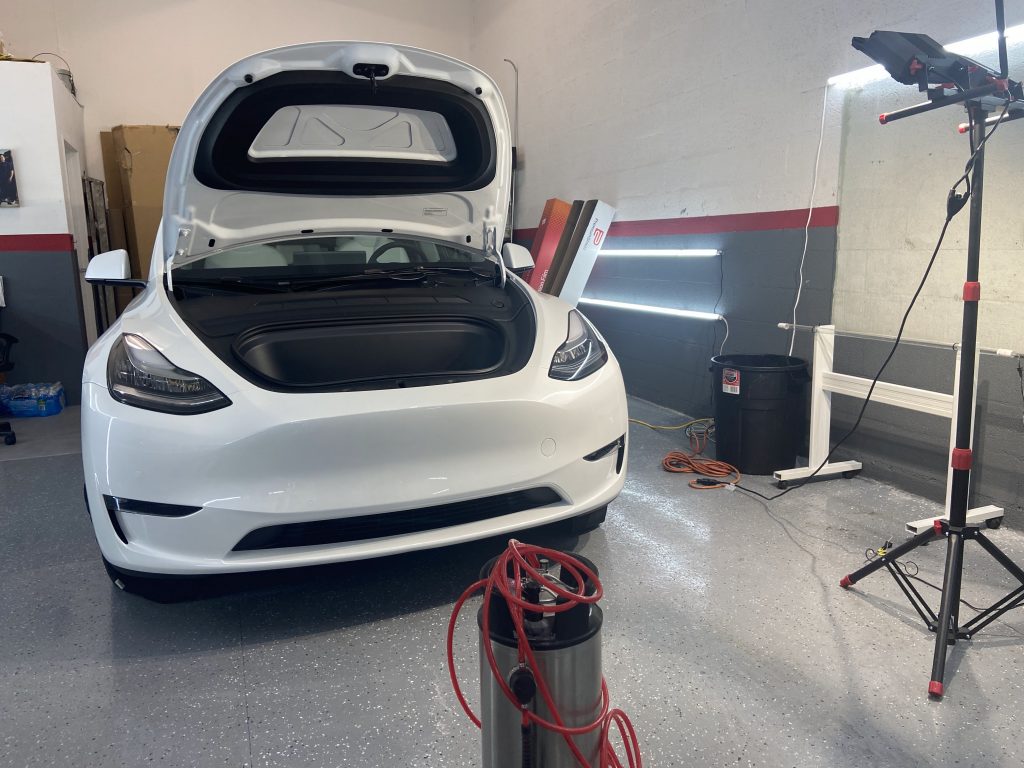 White Tesla Model 3 in the shop for paint protection film